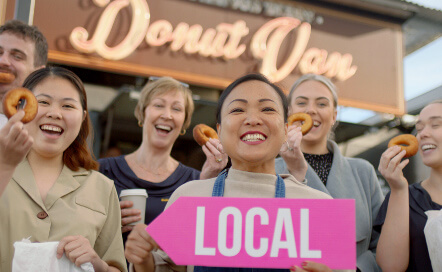 Smiling people outside Donut Van.